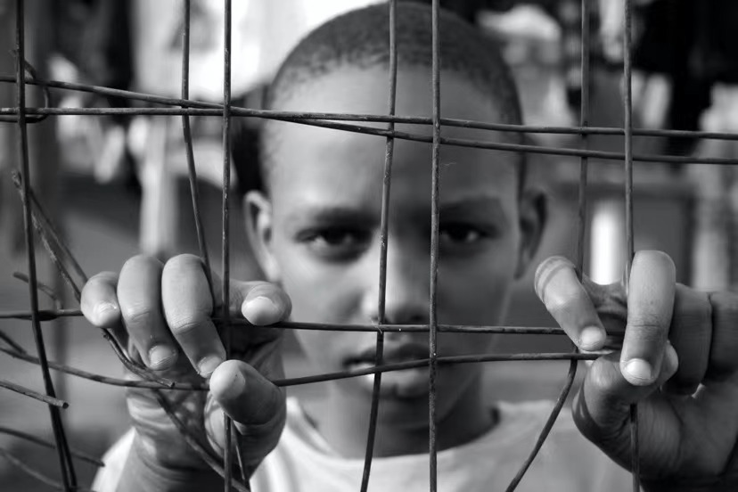 African boy behind bars.