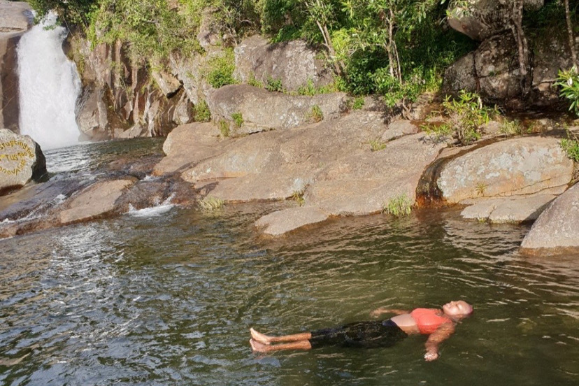 An African Woman swimming in a water body