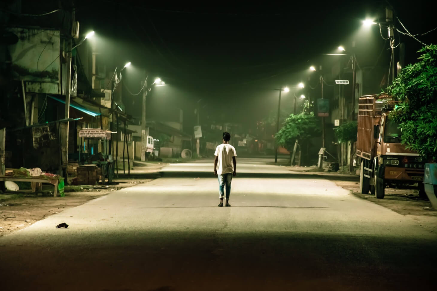 a boy walking on the streets alone.